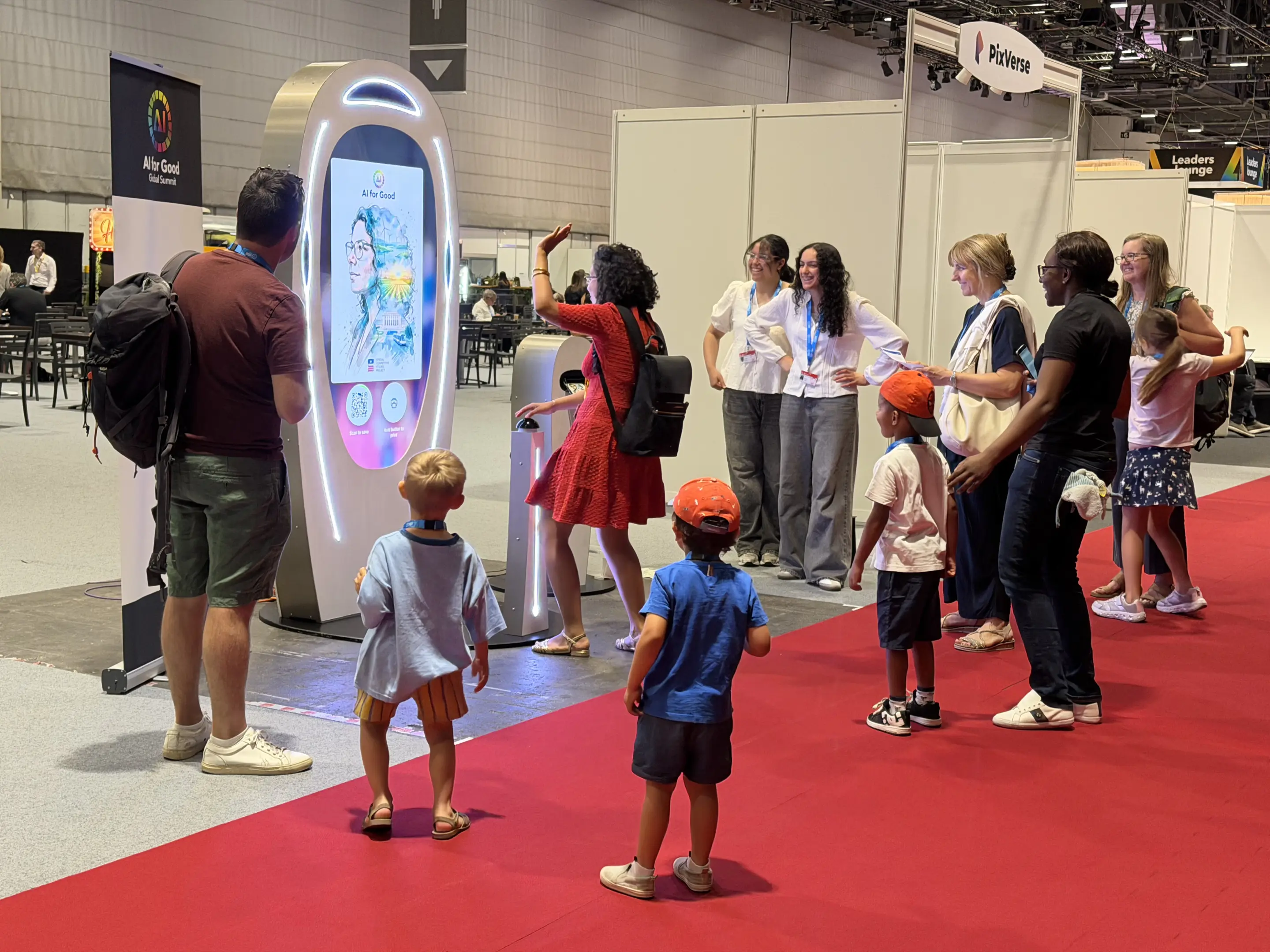 Visitors gather around a Poem Booth as a portrait appears on its screen at the AI for Good Global Summit.